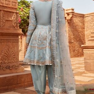 Up for grabs is a premium Dusty Blue Dhoti Style Punjabi Suit designed by Laksha